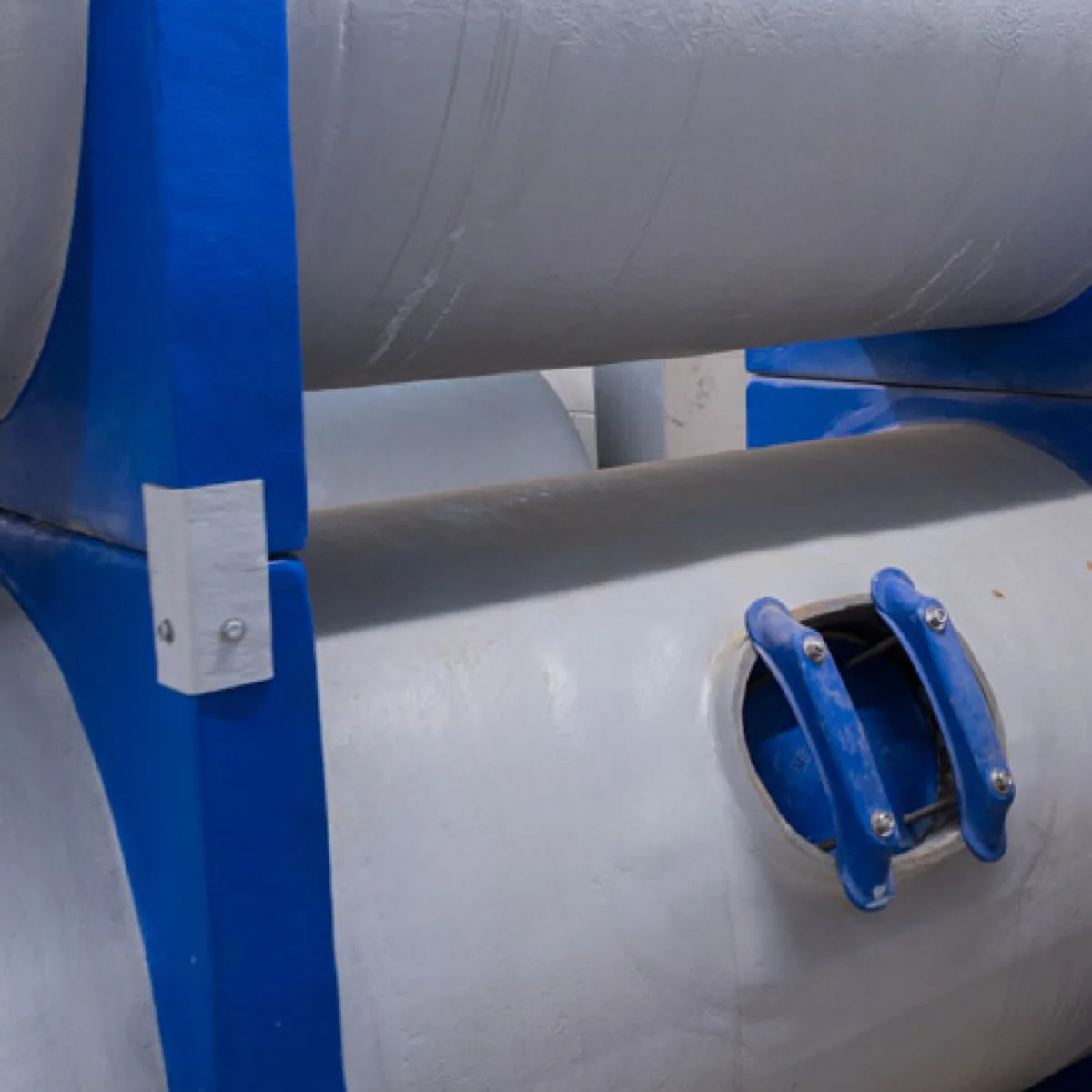 Dual-stacked Mer-Made fiberglass commercial pool sand filter system in a filter room