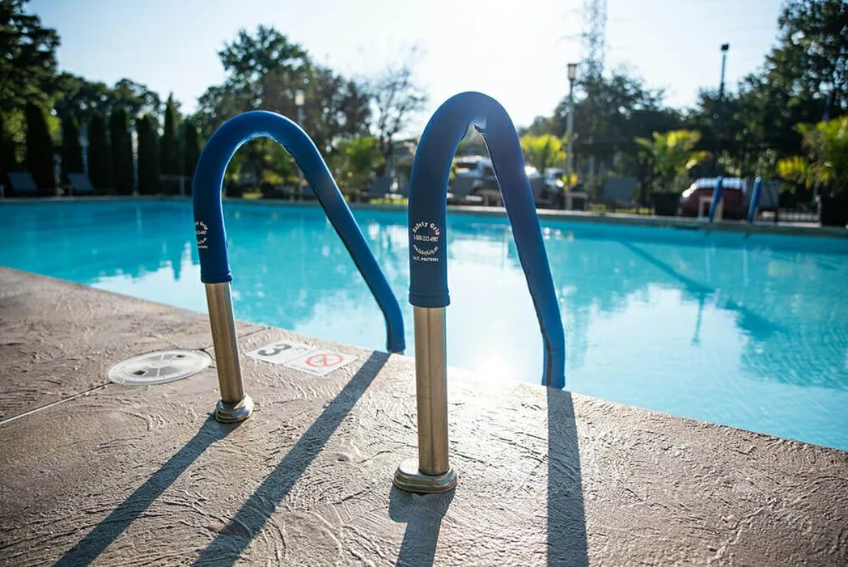 Safety Grip royal blue zippered handrail cover installed on a pool stair rail